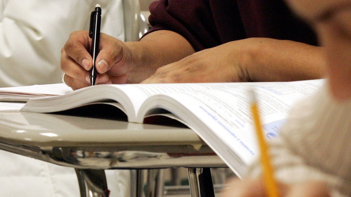 Students work out math problems during a class for Hispanic adults Wednesday, March 16, 2005, at Cary High School in Cary, N.C. (AP Photo/Karl DeBlaker)