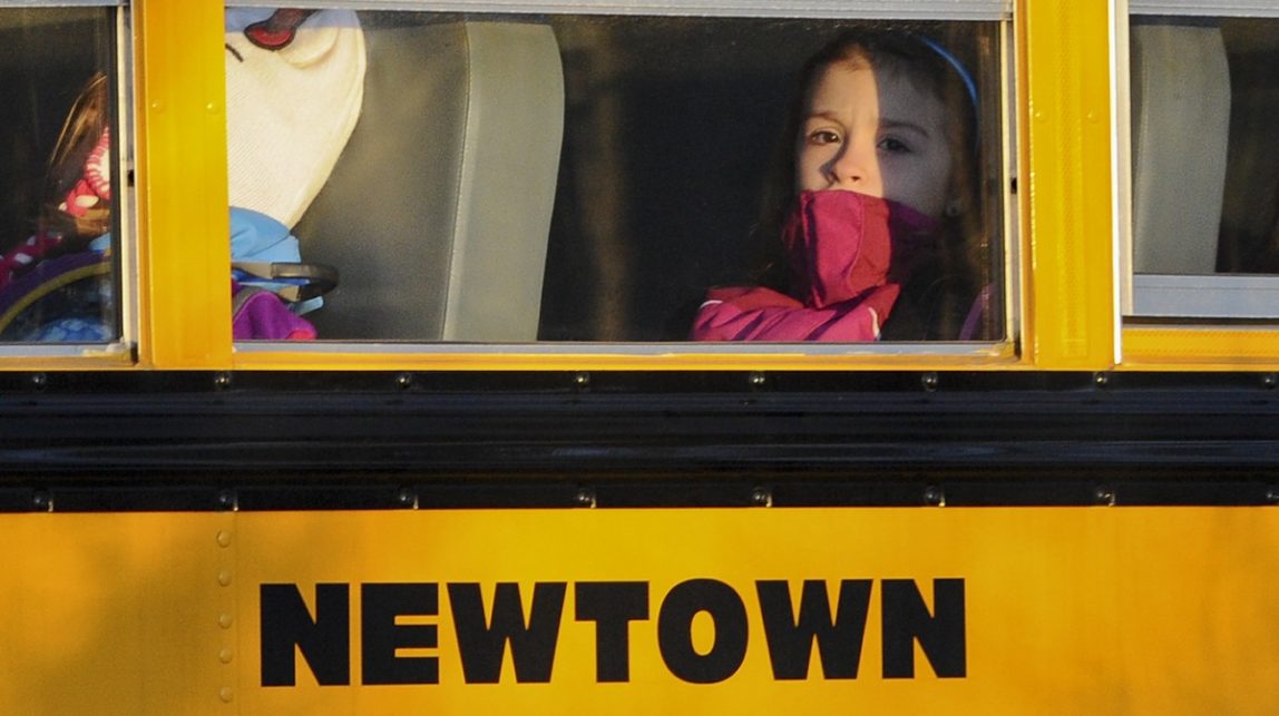 A girl sits on a Newtown bus leaving the new Sandy Hook Elementary School after the first day of classes in Monroe, Conn., Thursday, Jan. 3, 2013. (AP Photo/Jessica Hill) (AP Photo/Jessica Hill)
