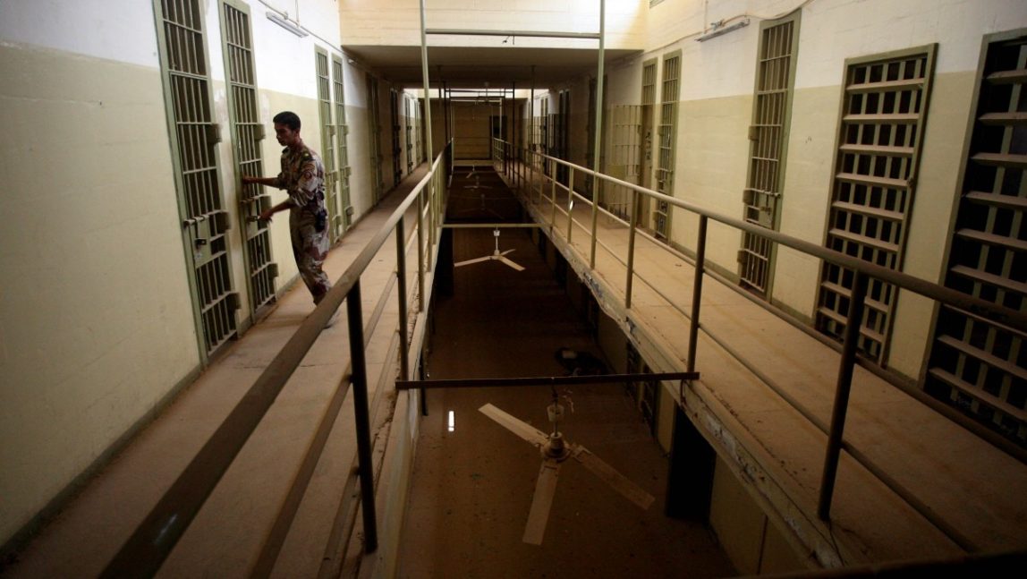 In this Sept. 2, 2006, file photo, an Iraqi army soldier closes the door of a cell, in Abu Ghraib prison after the Iraqi government took over control from U.S. forces, on the outskirts of Baghdad, Iraq. (AP Photo/Khalid Mohammed, File)