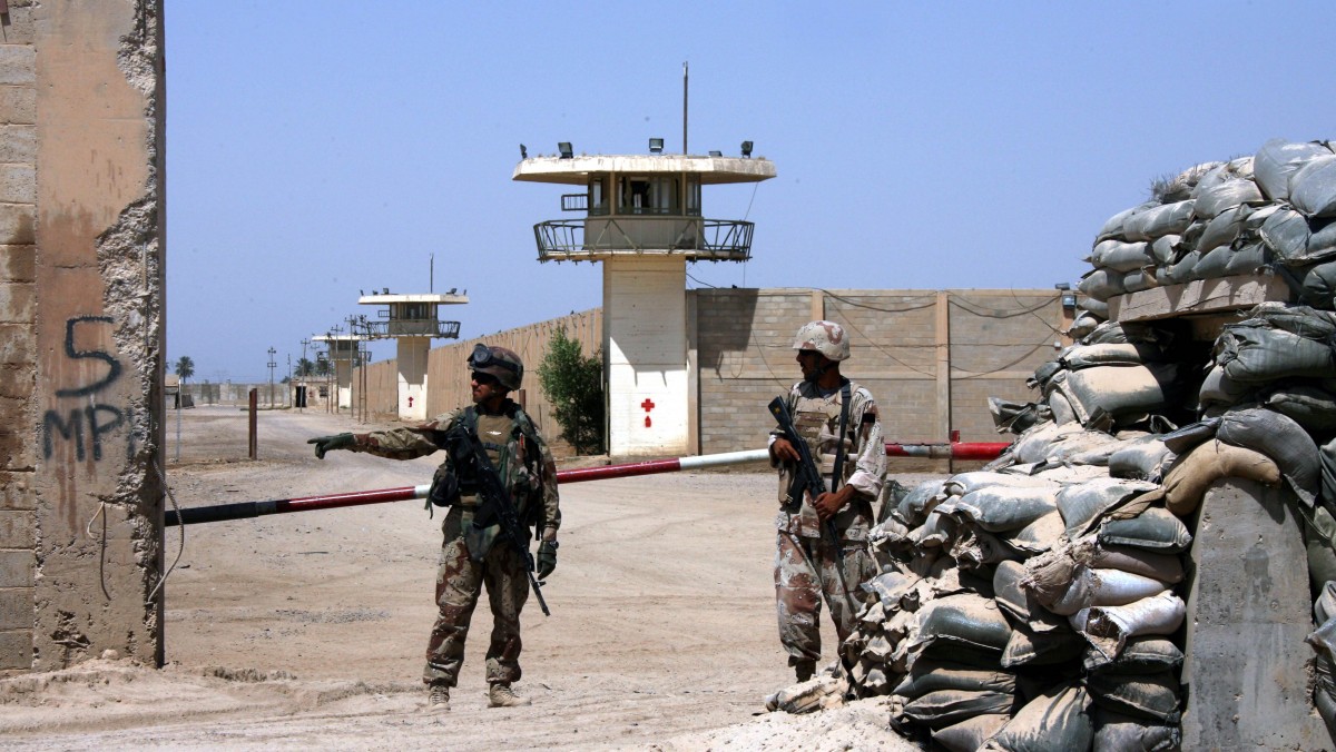 Iraqi soldiers stand guard at Abu Ghraib after taking over for U.S. soldiers, on the outskirts of Baghdad, Iraq. Khalid Mohammed | AP