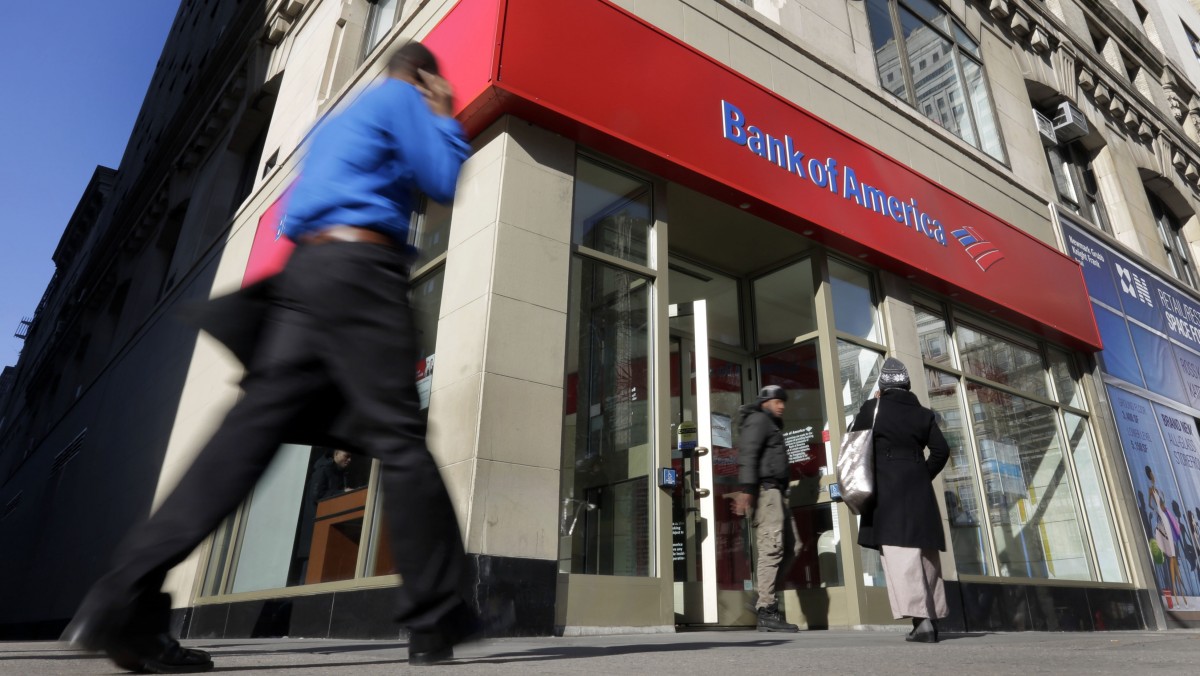 People pass a Bank of America branch, in New York, Monday, Jan. 7, 2013. (AP Photo/Richard Drew)