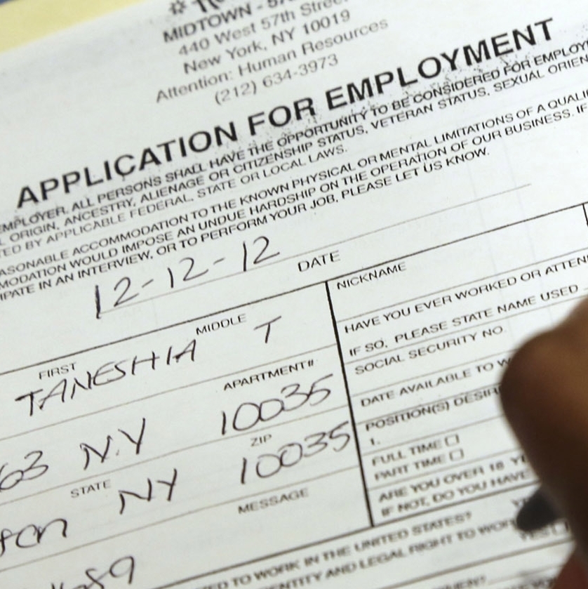 In this Wednesday, Dec. 12 2012 photo, Taneshia Wright, of Manhattan, fills out a job application during a job fair in New York. (AP Photo/Mary Altaffer)