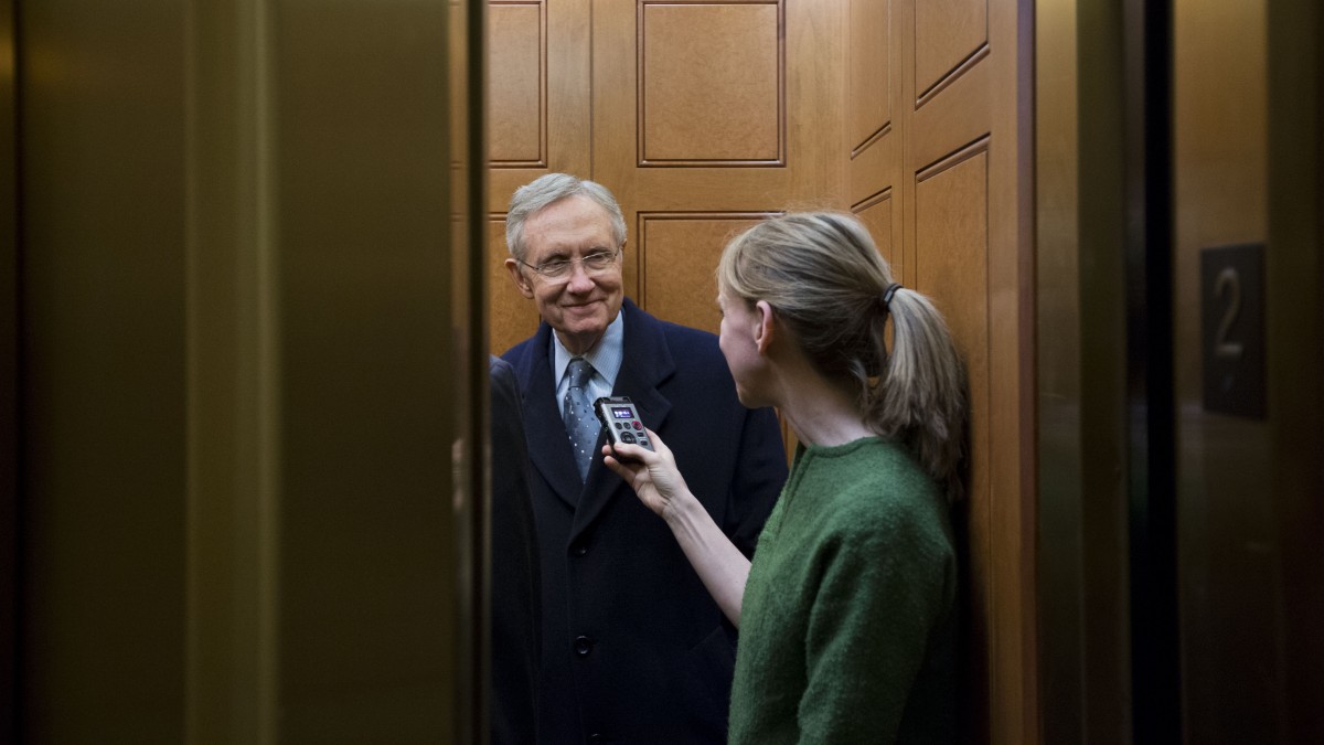 Senate Majority Leader Harry Reid, left, from Nevada, talks with a journalist as the elevator doors close as he departs the Capitol after a vote about the fiscal cliff, on Capitol Hill Tuesday, Jan. 1, 2013 in Washington. (AP Photo/Alex Brandon)