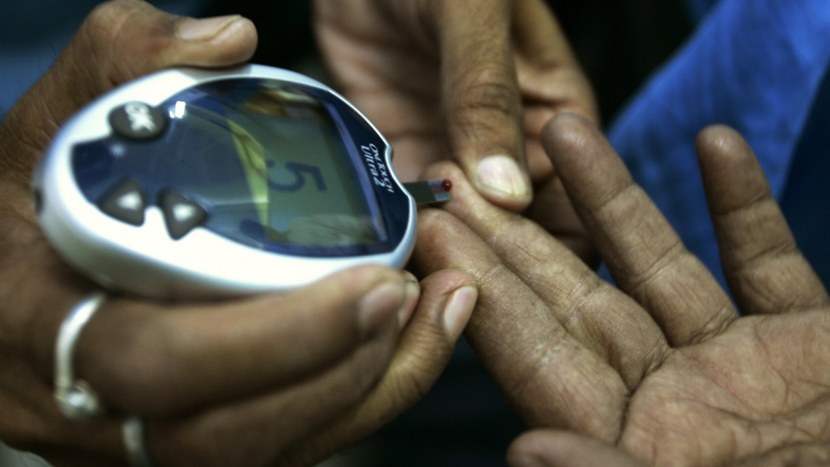 In this Nov. 14, 2008 file photo, a health worker, left, takes a blood sample from a diabetic patient's hand. (AP Photo/Bikas Das, File)