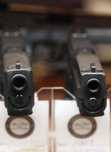 In this Jan. 4, 2013 photo, handguns are displayed in the sales area of Sandy Springs Gun Club and Range, in Sandy Springs, Ga. (AP Photo/Robert Ray)