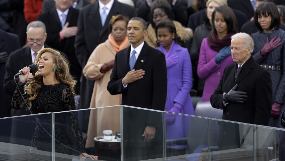 President Barack Obama and the first family listens as Beyonce signs the National Anthem at the ceremonial swearing-in at the U.S. Capitol during the 57th Presidential Inauguration in Washington, Monday, Jan. 21, 2013. (AP Photo/Carolyn Kaster)