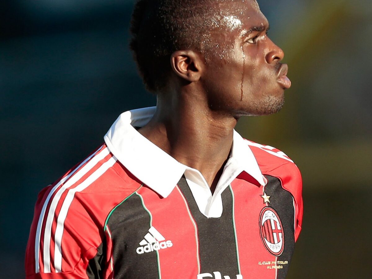 In this picture made available Friday, Jan. 4, 2013, AC Milan M'Baye Niang, of France, left, is held back from an unidentified Pro Patria player as he gestures towards the crowd in Busto Arsizio, near Milan, Italy, Thursday, Jan. 3, 2013. (AP Photo/Emilio Andreoli)
