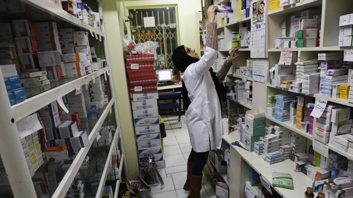 In this Tuesday, Dec. 11, 2012 photo, an Iranian pharmacist arranges medicine on shelves at a pharmacy in central Tehran, Iran. While medicine and humanitarian supplies are not blocked by the economic embargoes on Iran over its nuclear program, the pressures are clearly evident in nearly every level of Iranian health care. It’s a sign of the domino effect of sanctions on everyday life. (AP Photo/Vahid Salemi)