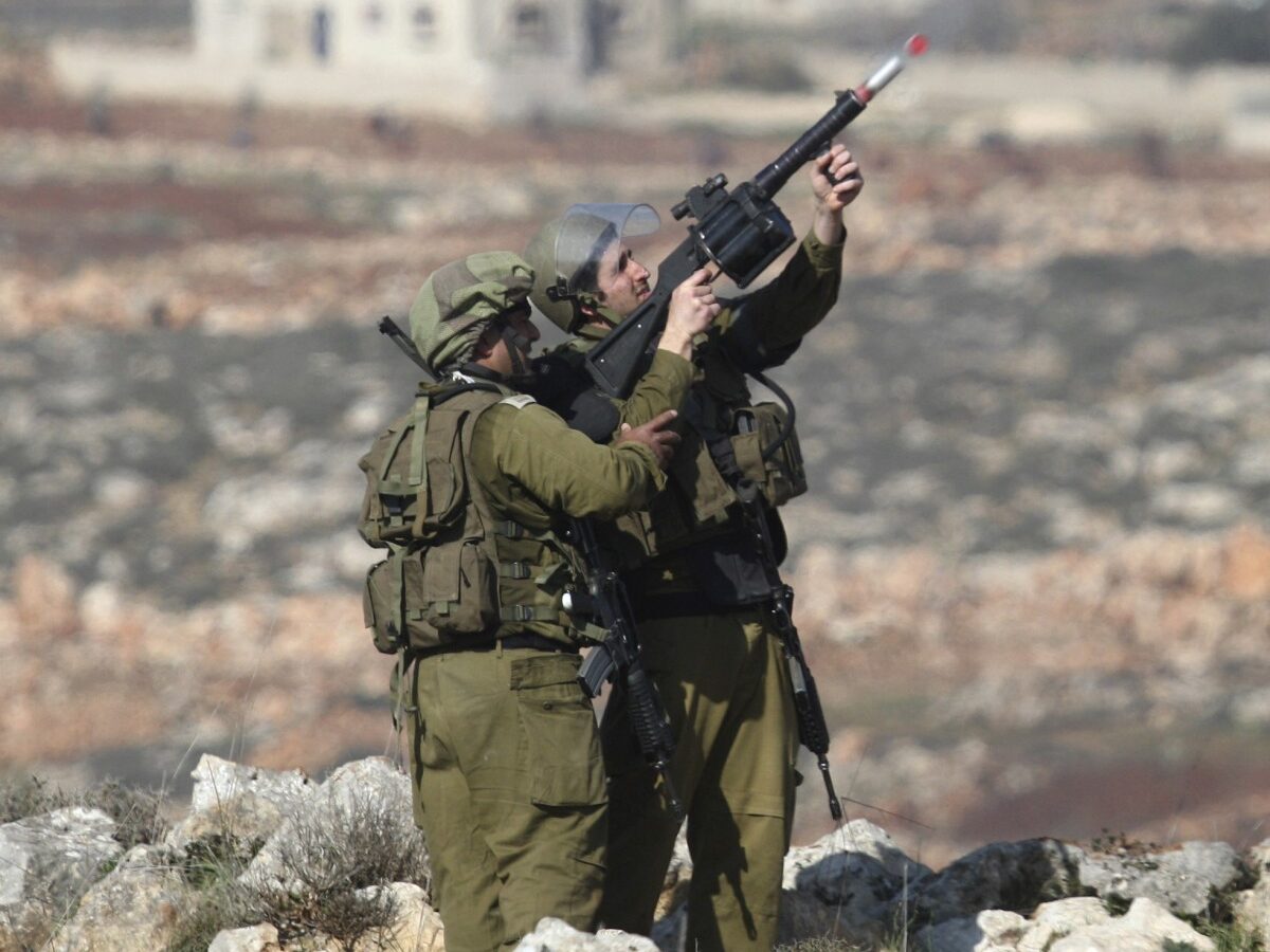 Israeli soldiers fire tear gas during clashes with Palestinian protesters, not seen, near the west bank village of Qusra, near Nablus, Tuesday, Jan. 1, 2013. (AP Photo/Nasser Ishtayeh)