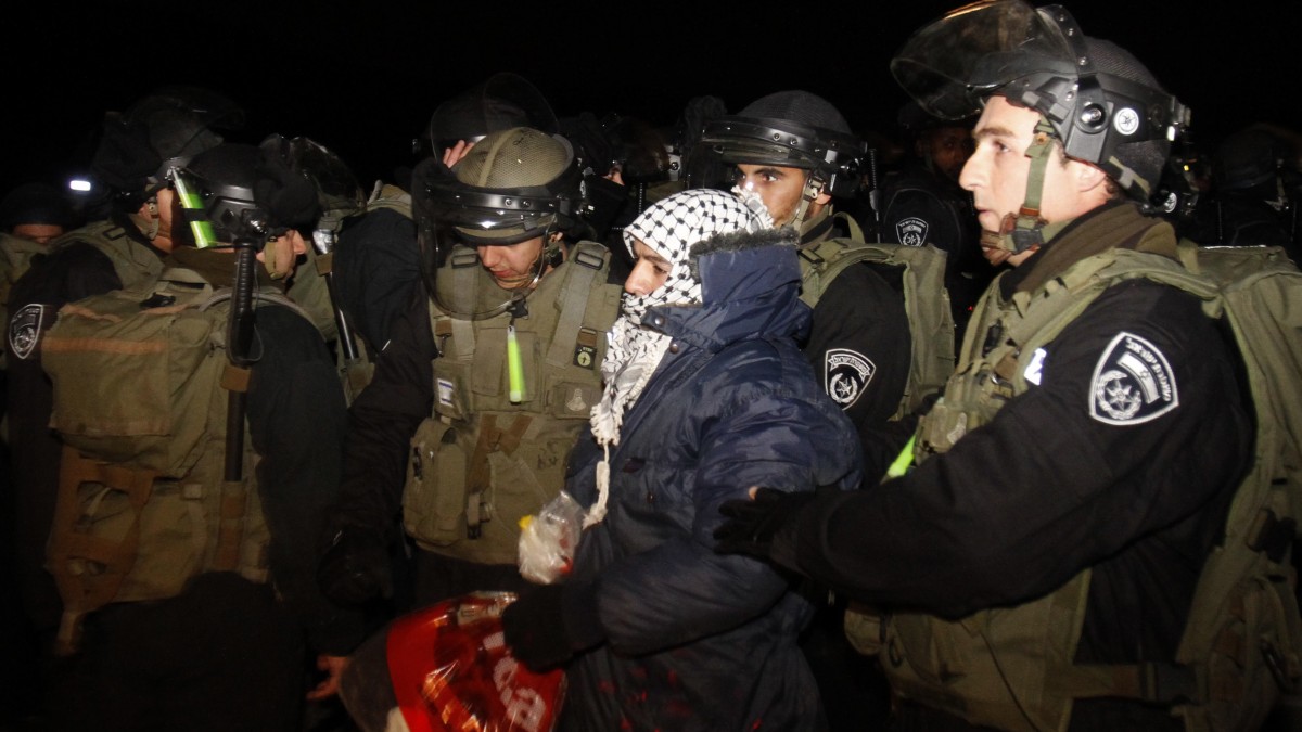 Israeli border police evict a Palestinian activist from an area known as E-1 near Jerusalem, Sunday, Jan 13, 2013. (AP Photo/Nasser Shiyoukhi)
