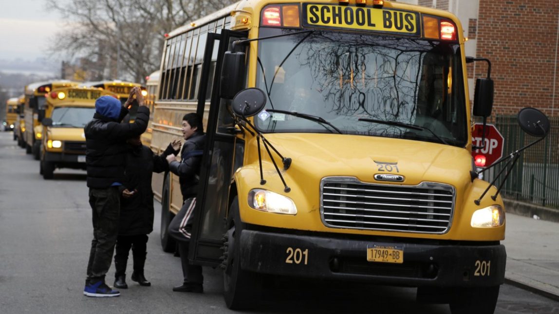 School buses line up to drop off students in New York, Tuesday, Jan. 15, 2013. (AP Photo/Seth Wenig)