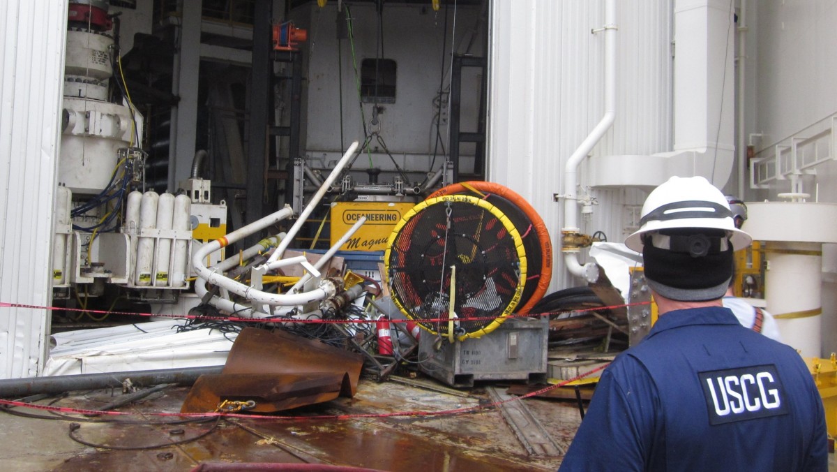 This Jan. 10, 2013, photo provided by the U.S. Coast Guard shows an inspector surveying damaged parts and equipment aboard the Shell Arctic drilling rig Kulluk in Kiluida Bay, near Kodiak, Alaska. (AP Photo/U.S. Fish and Wildlife Service)
