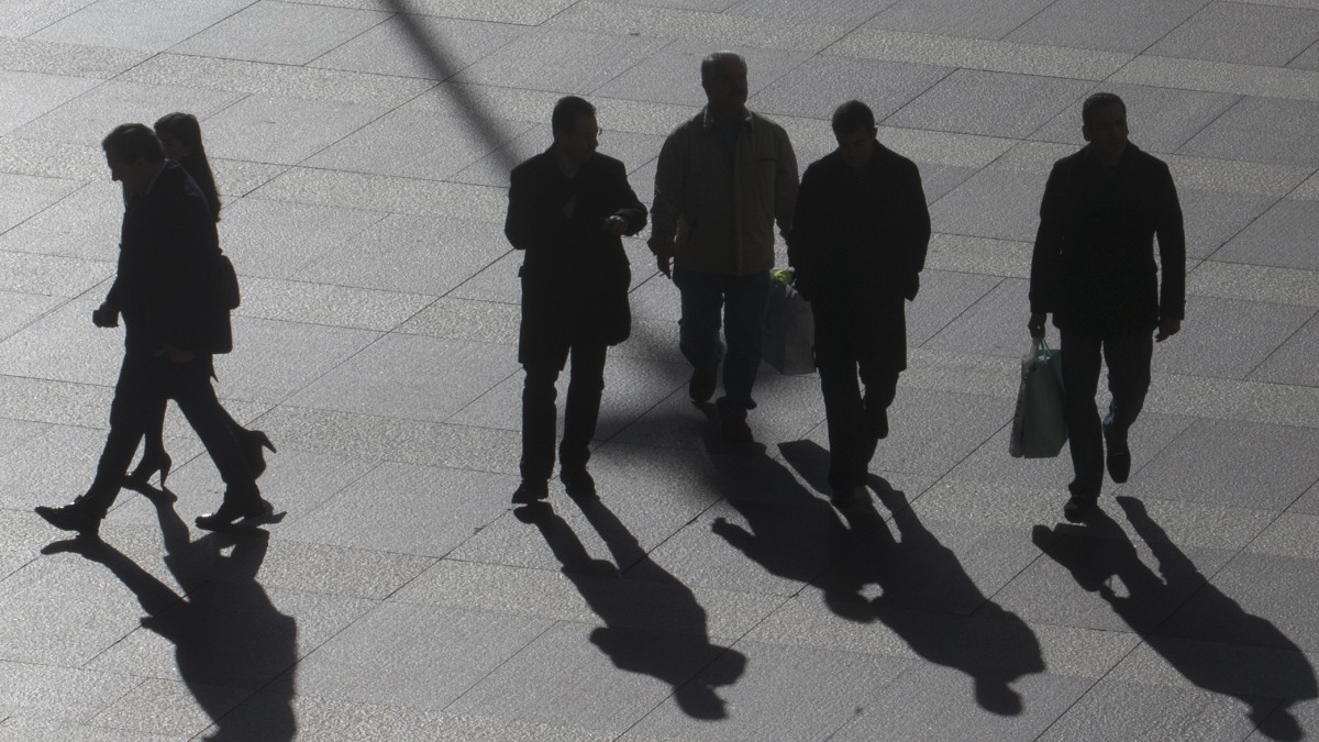 Office workers walk in the business district of Madrid, Tuesday Jan. 15, 2013. (AP Photo/Paul White)
