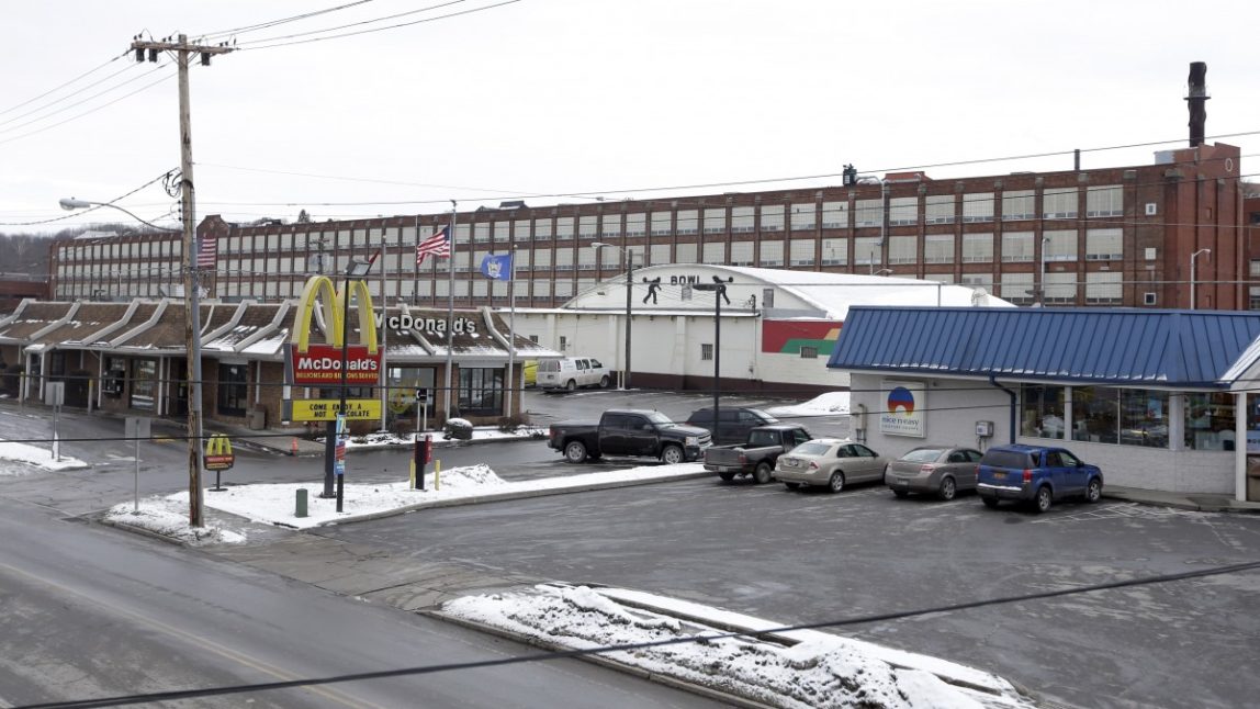 In this Thursday, Jan. 17, 2013, photo, the Remington Arms Company stands behind a McDonalds, a bowling center and a convenient store in Ilion, N.Y. (AP Photo/Mike Groll)
