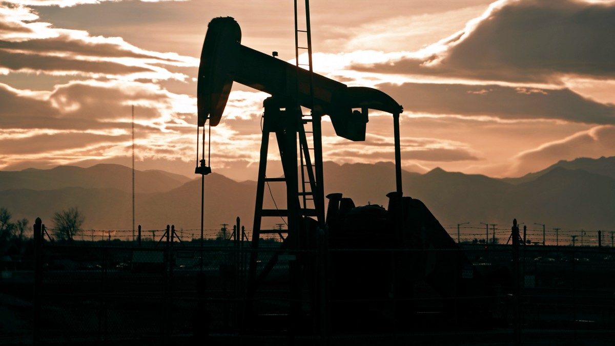 In this Dec. 5, 2012 photo, the sun sets behind an oil pump jack and the Rocky Mountains near Fredrick, Colo. (AP Photo/Ed Andrieski)