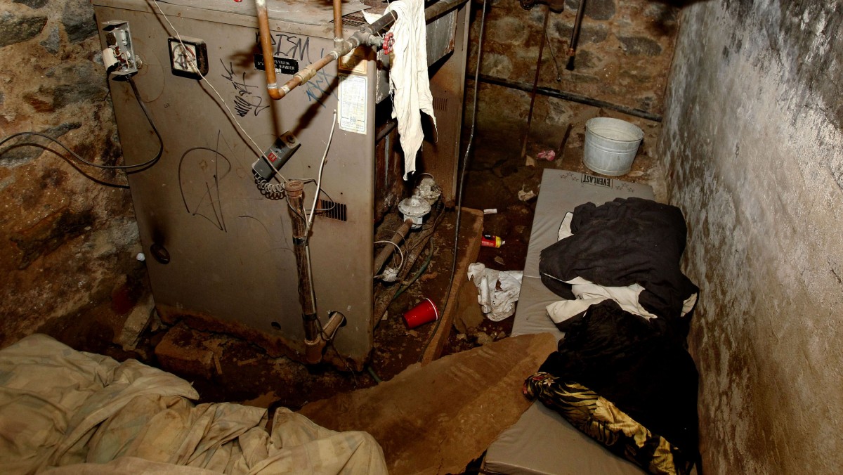 The dank basement room in Philadelphia where four weak and malnourished mentally disabled adults, one chained to the boiler, were found locked inside on Saturday is shown Monday, Oct. 17, 2011. (AP Photo/Ron Cortes, Pool)