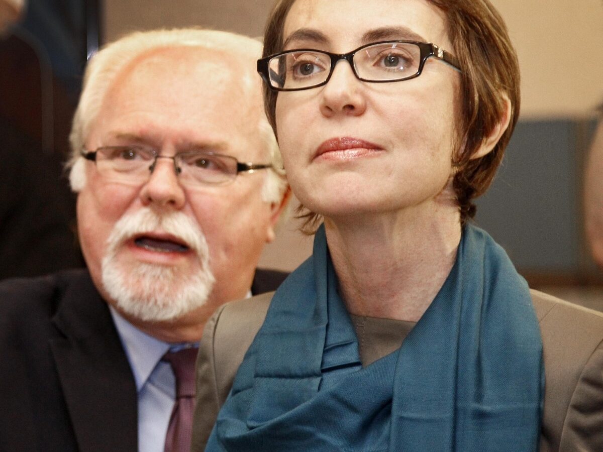 This Jan. 23, 2012 file photo shows U.S. Rep Gabrielle Giffords, D-Ariz., touring the Gabrielle Giffords Family Assistance Center, one of her favorite charities, with her staffer Ron Barber in Tucson, Ariz. (AP Photo/Matt York, Pool, File)