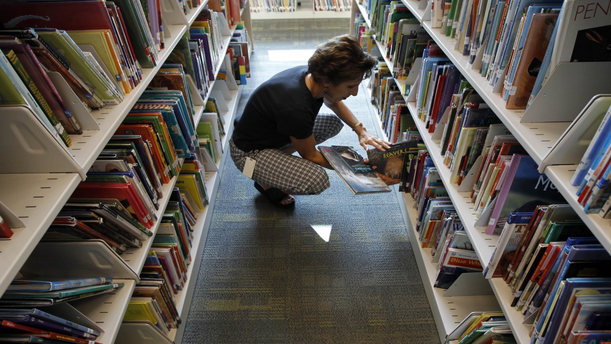 A woman looks through books at a library Friday, Sept. 30, 2011 in Lancaster, Pa. (AP Photo/Alex Brandon)