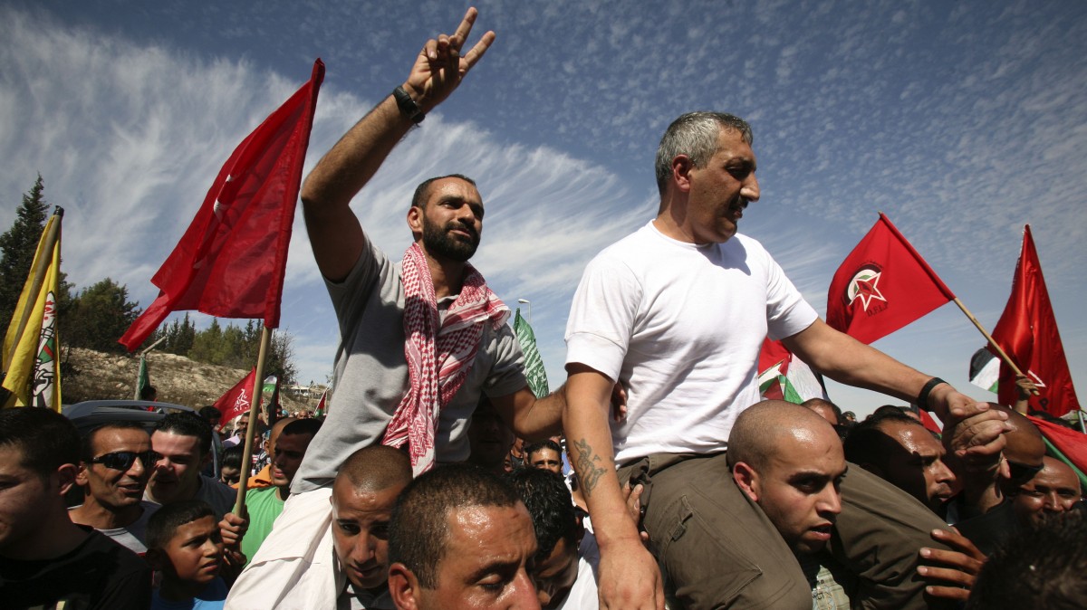 Khaled Muhasen, right and Samer Tareq al-Issawi are carried shoulder high after they were released from Israeli prison, Tuesday, Oct. 18, 2011 in Jerusalem. (AP Photo/Muammar Awad)