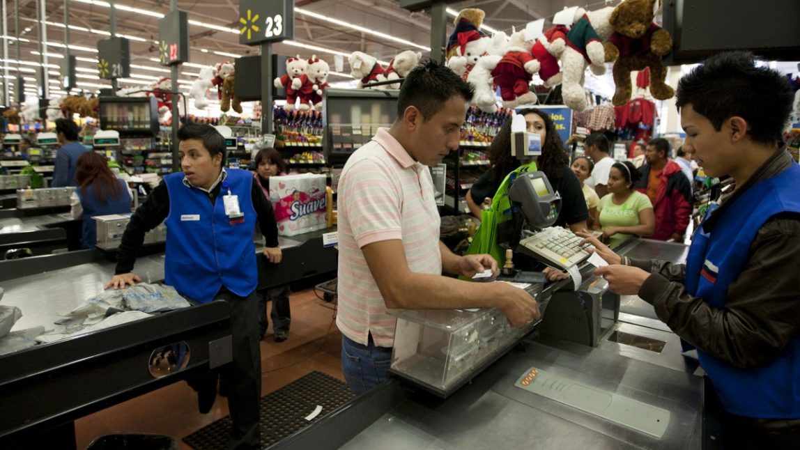 In this Nov. 18, 2011 file photo, a man pays at the cash register at a Wal-Mart Superstore in Mexico City. (AP Photo)