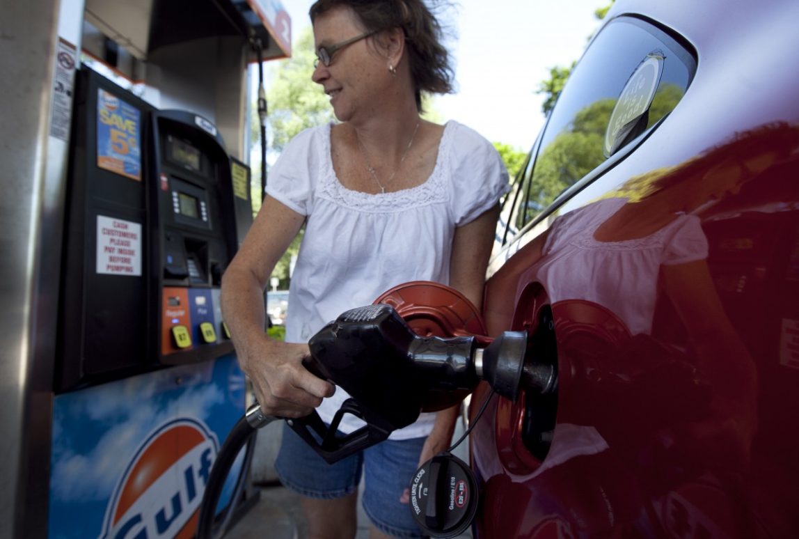 In this July 10, 2012 file photo, Suzanne Meredith, of Walpole, Mass., gases up her car at a Gulf station in Brookline, Mass. (AP Photo/Steven Senne, File)