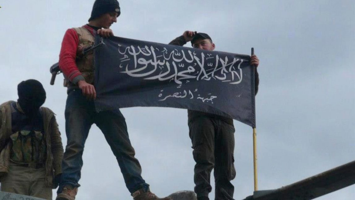 Jabhat al-Nusra, wave their brigade flag.