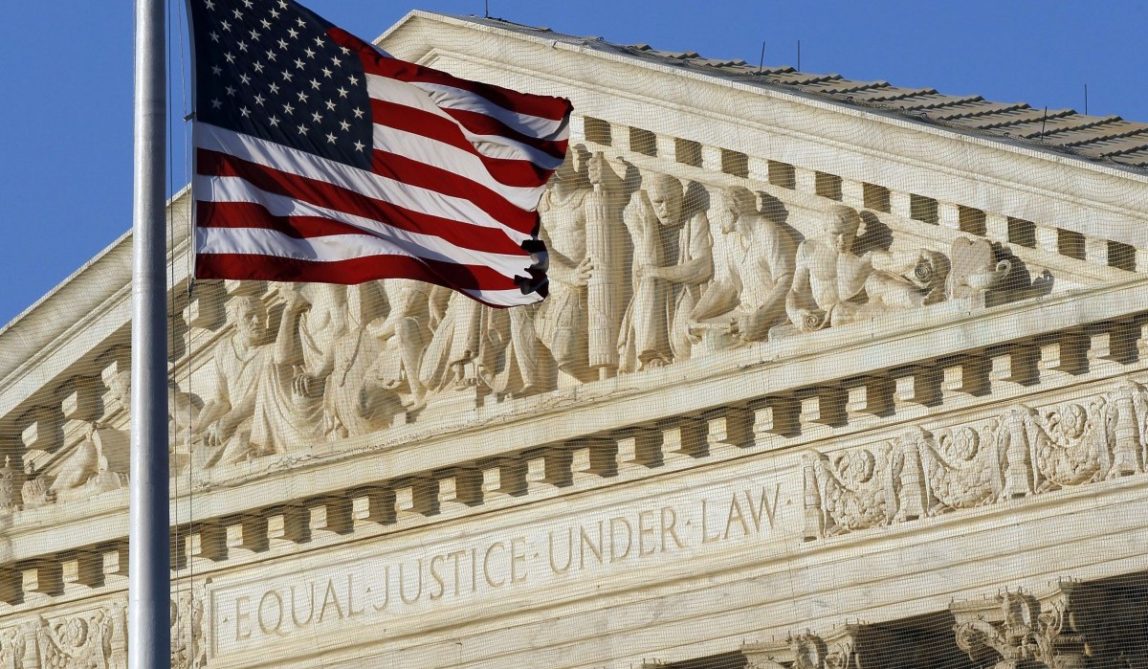 an American flag flies in front of the Supreme Court in Washington