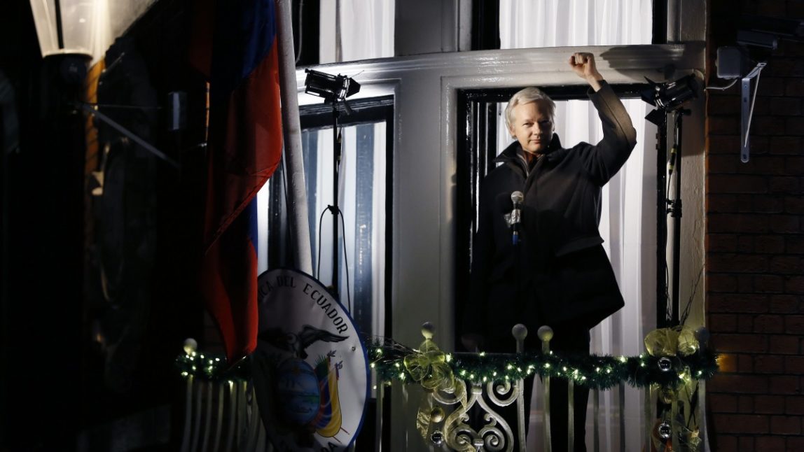 Julian Assange, founder of WikiLeaks, gestures as he speaks to the media and members of the public from a balcony at the Ecuadorian Embassy in London, where he has been taking refuge to avoid extradiction to Sweden. His WikiLeaks Party is in the running to win Senate seats in Australia, according to polls. (AP Photo/Kirsty Wigglesworth)