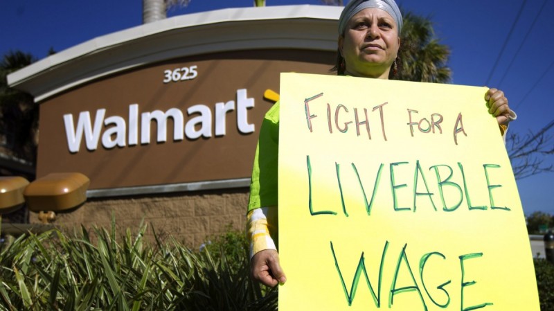 Nawal Elmilliax joins the protest against Wal-Mart in Boynton Beach, Fla., Friday, Nov 23, 2012. (AP Photo/J Pat Carter)