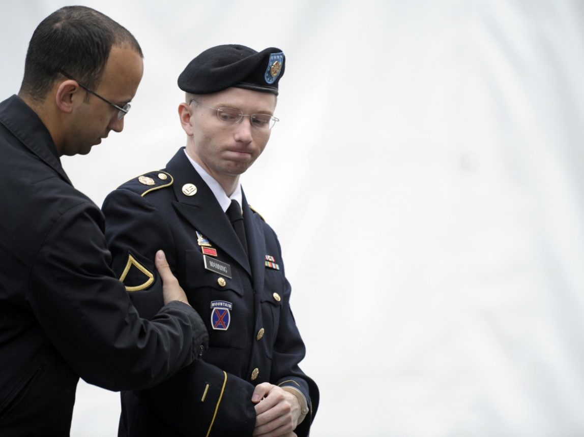Army Pfc. Chelsea Manning, right, is escorted into a courthouse at Fort Mead, Md., Monday, June 10, 2013. (AP Photo/Cliff Owen)