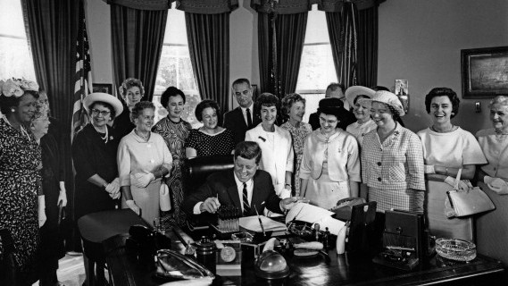 American Association of University Women members with President John F. Kennedy as he signs the Equal Pay Act into law. (Public domain photo/Abbie Rowe/JFK Presidential Library and Museum)