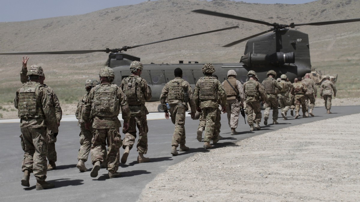NATO solders walk towards a Chinook helicopter after a ceremony at a military academy on the outskirts of Kabul, Afghanistan, Tuesday, June 18, 2013. (AP/Rahmat Gul)