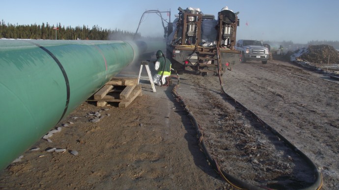 Construction workers work on a pipeline in Alberta, Canada. (Photo/jasonwoodhead23 via Flickr)