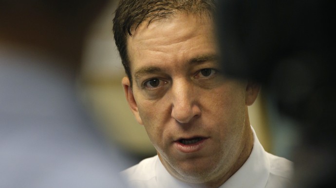 Glenn Greenwald, a reporter of The Guardian newspaper, speaks to The Associated Press after a after a live interview in Hong Kong Tuesday, June 11, 2013. Greenwald reported a 29-year-old contractor who claims to have worked at the National Security Agency and the CIA allowed himself to be revealed Sunday as the source of disclosures about the U.S. government's secret surveillance programs, risking prosecution by the U.S. government. (AP Photo/Vincent Yu)