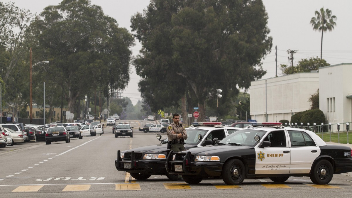 A Los Angeles County Sheriff's officer stands by his car in Santa Monica, Calif. on Saturday, June 8, 2013. (AP/Ringo H.W. Chiu)