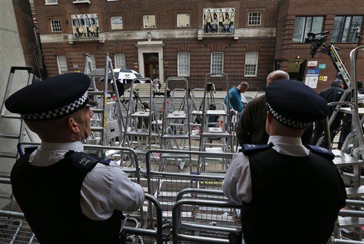 British police officers watch as stepladders are placed by members of the media outside St. Mary's Hospital exclusive Lindo Wing in London, Wednesday, July 3, 2013. (AP Photo/Lefteris Pitarakis)