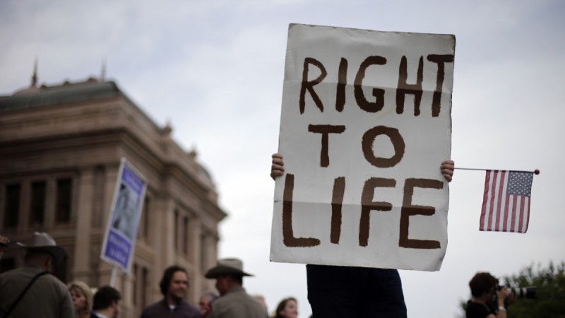 File: A man holds a sign during an anti-abortion rally at the Texas Capitol, Monday, July 8, 2013. (AP Photo/Eric Gay)