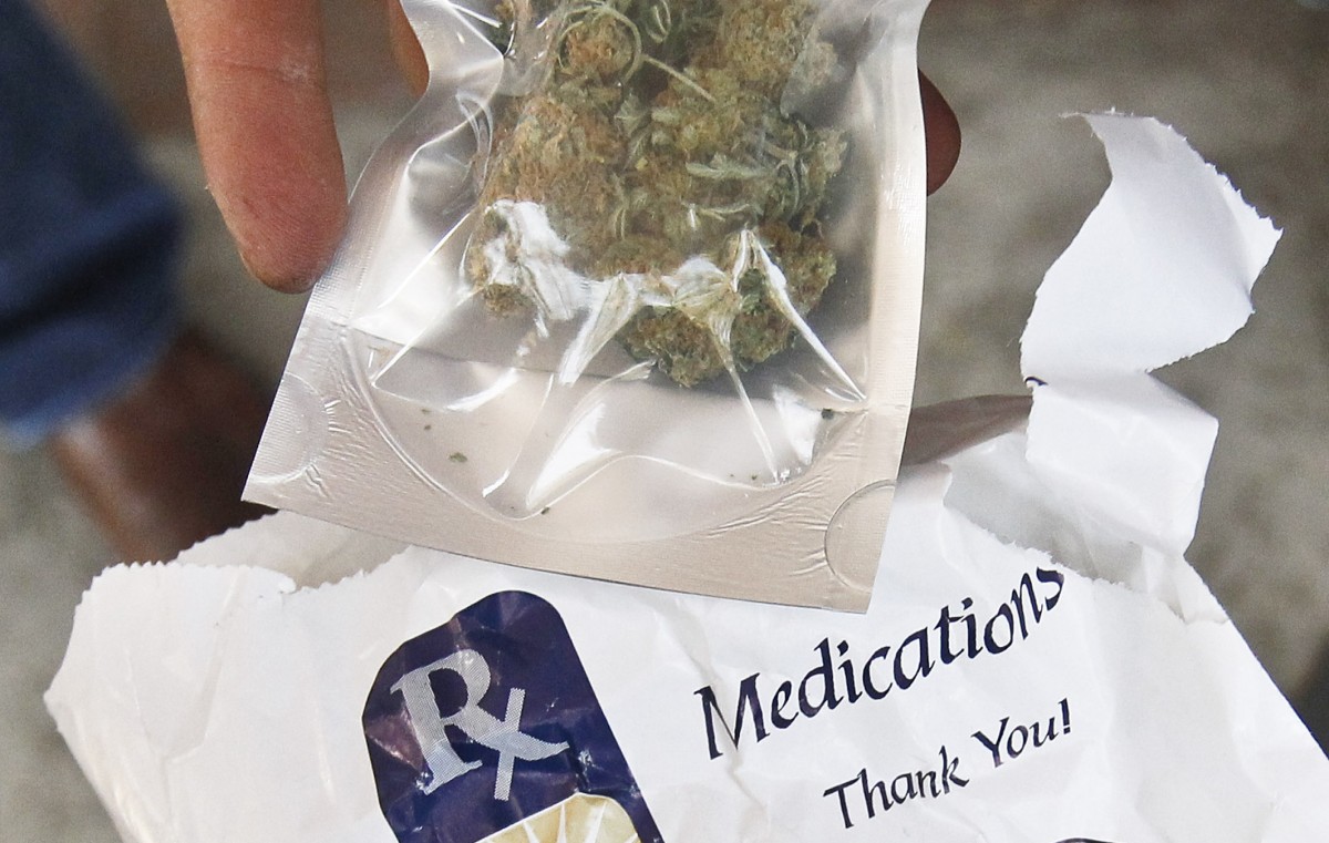 Michael Cardenas shows off his medical marijuana after purchase outside Arizona Organix, the first legal medical marijuana dispensary to open in Arizona. AP Photo.