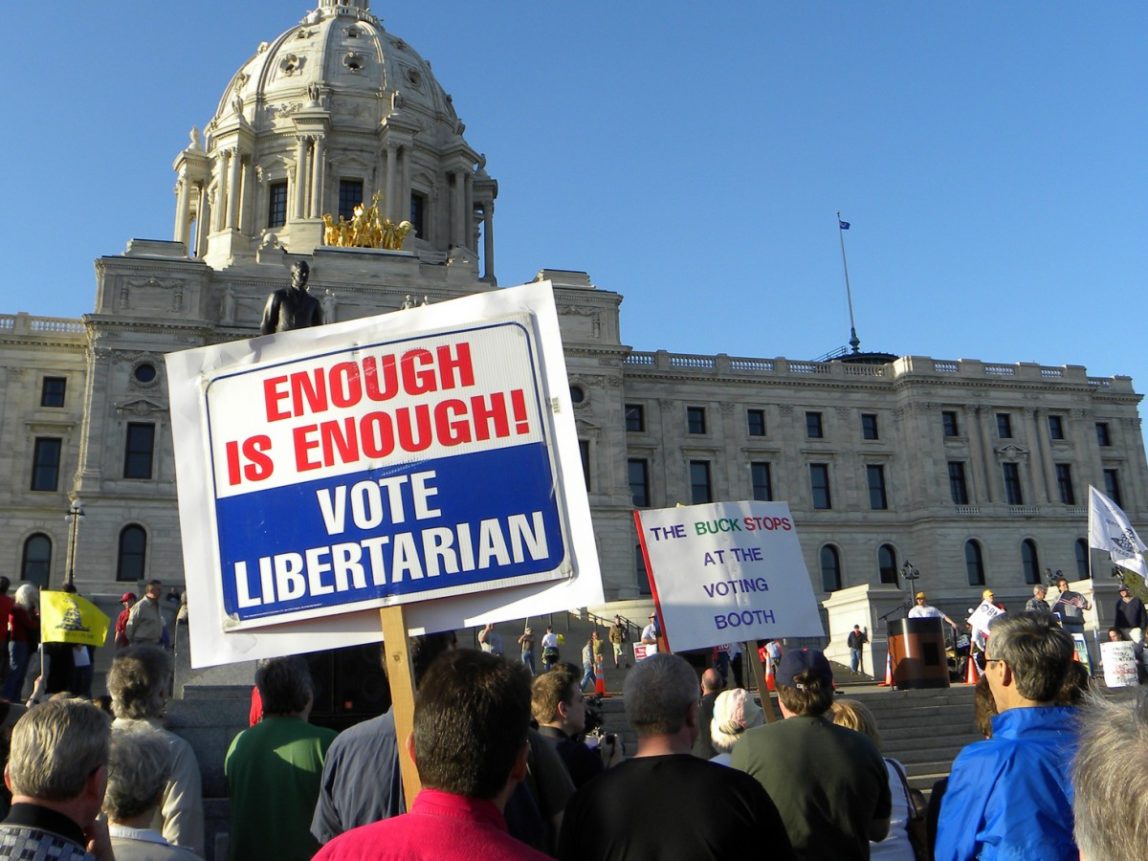 Pictured, a tax day protest in St. Paul, Minn. Libertarians and socialists make for strange bedfellows, but bedfellows nonetheless, argues the author. (Photo/Fibonacci Blue via Flickr)