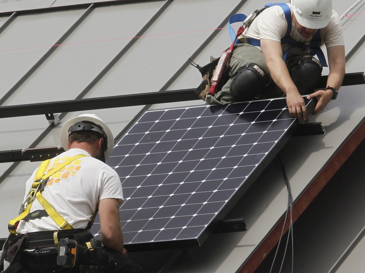 Workers install a solar panel for SunCommon on Monday, April 29, 2013 in Montpelier, Vt. (AP Photo/Toby Talbot)