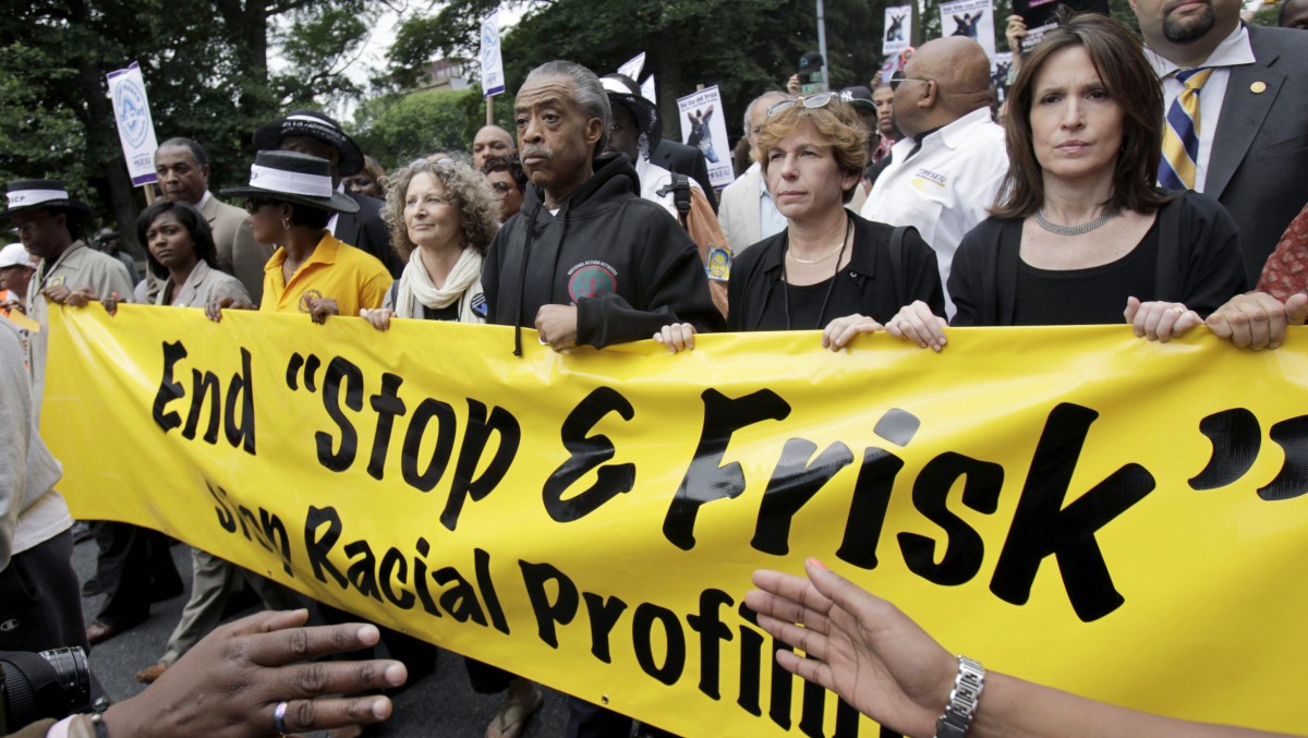 The Rev. Al Sharpton, center, walks with demonstrators during a silent march to end the "stop-and-frisk" program in New York, Sunday, June 17, 2012. . (AP Photo/Seth Wenig)