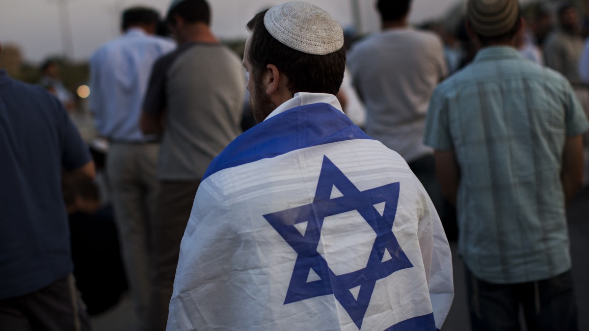 Israeli settlers pray in Tapuah junction, near the West Bank city of Nablus, Palestine. (AP Photo/Bernat Armangue)