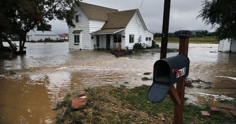 Water flows through an evacuated neighborhood after days of flooding in Hygeine, Colo., Sunday Sept. 15, 2013. After somewhat abating for two days, rain returned to Colorado Sunday, creating a risk of more flooding and mudslides. (AP Photo/Brennan Linsley)
