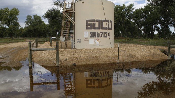 In this Wednesday, Sept. 18, 2013 photo, an oil well pump site is reflected in flood waters near Greeley, Colo. Colorado’s floods shut down hundreds of natural gas and oil wells, spilled oil from one tank and sent inspectors into the field looking for more pollution. Besides the environmental impact, flood damage to roads, railroads and other infrastructure will affect the region’s energy production for months to come.  Analysts warn that images of flooded wellheads will increase public pressure to impose restrictions on drilling techniques such as fracking.(AP Photo/Ed Andrieski)