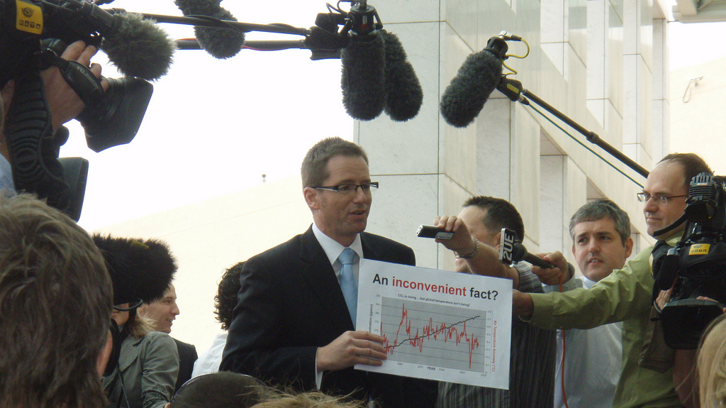 Former Australian politician Steve Fielding holds a sign reflecting his views that climate change isn't a man-made phenomenon, despite near-unanimous scientific reporting the contrary, in Canberra, Australia, Nov. 29, 2009. A new study shows that people tend to stick with their political views even when they are disproved by the facts. (Photo