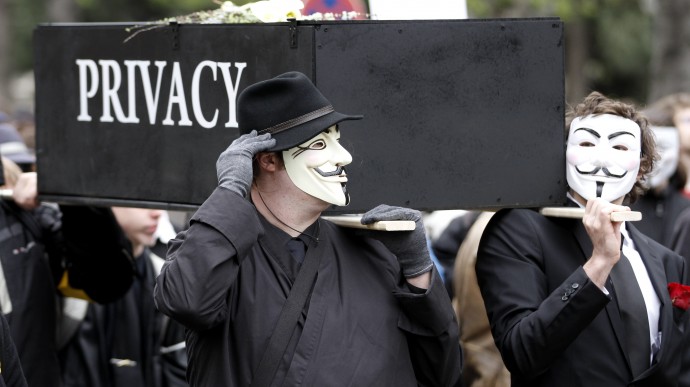 Protesters with Guy Fawkes masks to protest on Saturday (31.03.12) in Vienna (Austria) with a replica of a coffin bearing the words "privacy" against data retention. Data connection of telephone, Internet and E-mail are from 1 April for six months gespeichert.Foto: Ronald Zak / DAPD