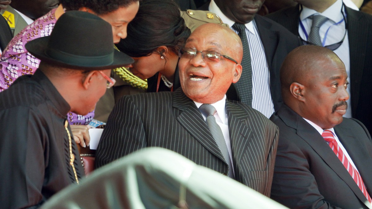 South African President Jacob Zuma, center, laughs with Nigerian President Goodluck Jonathan, left, as Congo's President Joseph Kabila, right, observes the proceedings at the inauguration of Kenya's President Uhuru Kenyatta in Kasarani, near Nairobi in Kenya Tuesday, April 9, 2013. Uhuru Kenyatta, 51, the son of Kenya's first president, was sworn in as Kenya's fourth president Tuesday in a stadium filled with tens of thousands of Kenyans and a dozen African leaders, becoming the second sitting African president to face charges at the International Criminal Court, over allegations he helped orchestrate the vicious tribe-on-tribe violence that marred Kenya's previous 2007 presidential election. (AP Photo/Khalil Senosi)