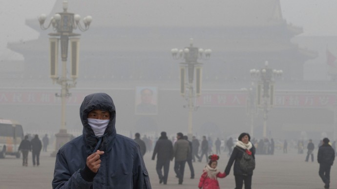 A man wears a mask on Tiananmen Square in thick haze in Beijing Tuesday, Jan. 29, 2013. Extremely high pollution levels shrouded eastern China for the second time in about two weeks Tuesday, forcing airlines in Beijing and elsewhere to cancel flights because of poor visibility and prompting government warnings for residents to stay indoors. (AP Photo/Ng Han Guan)