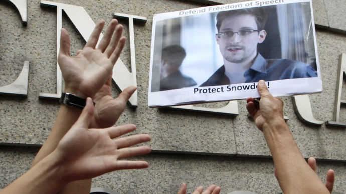 Supporters hold a picture of Edward Snowden outside the Consulate General of the United States in Hong Kong Thursday, June 13, 2013 as they urge the U.S. government to pardon Edward Snowden and to apologize for the surveillance. Edward Snowden, former CIA employee who leaked top-secret documents about sweeping U.S. surveillance programs, dropped out of sight after checking out of a Hong Kong hotel on Monday. The Hong Kong newspaper South China Morning Post said it was able to locate and interview him on Wednesday. It provided brief excerpts from the interview on its website. (AP Photo/Kin Cheung)
