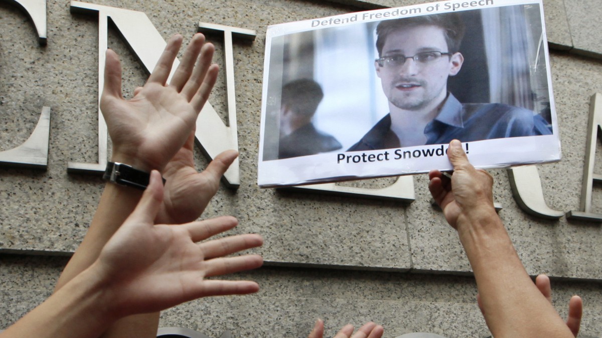 Supporters hold a picture of Edward Snowden outside the Consulate General of the United States in Hong Kong Thursday, June 13, 2013. (AP Photo/Kin Cheung)
